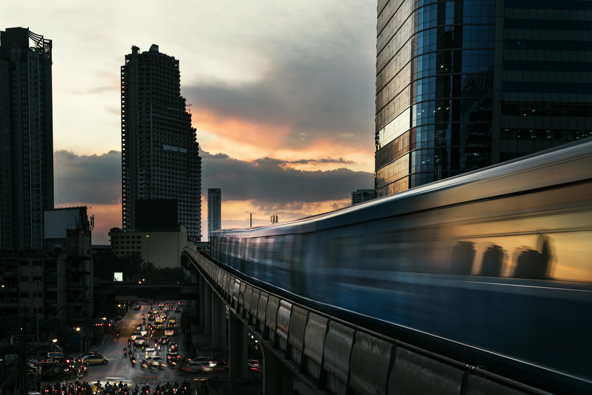 A RapidKL train on an elevated line over the Kuala Lumpur skyline