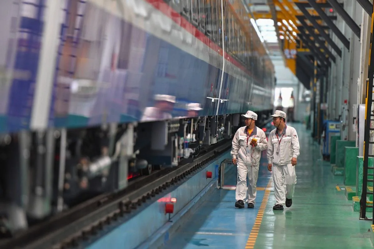 Engineers inspecting a train in the depot