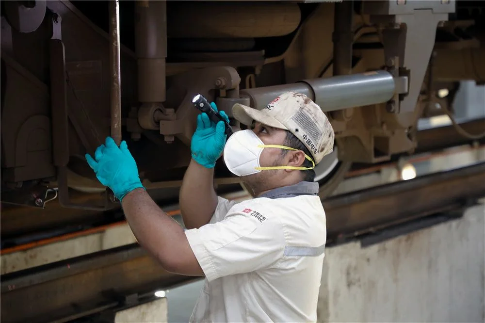 A technician inspecting bogie components