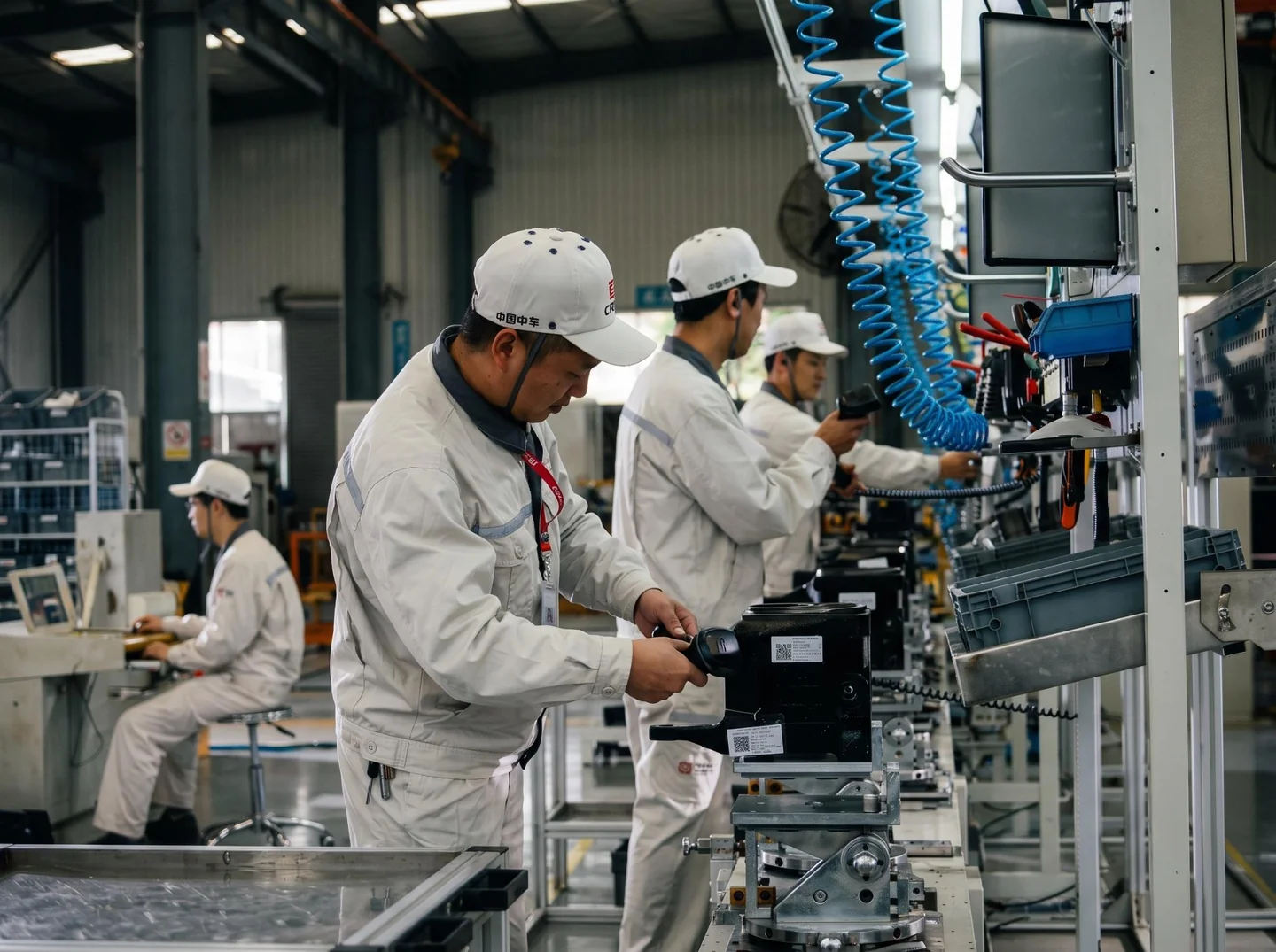 Engineers walking a rolling stock assembly line